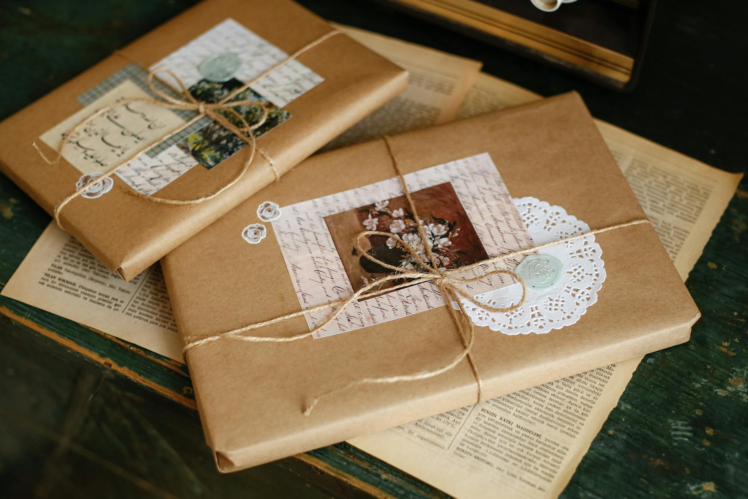 Close-up of books wrapped in vintage style kraft paper with decorative elements.